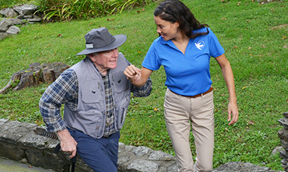 A Visiting Angels caregiver assisting an elderly woman with mobility aids, demonstrating fall prevention strategies in a home environment.