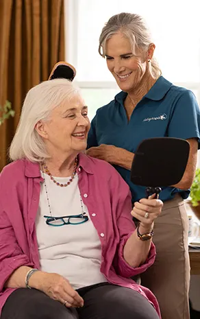 A Visiting Angels caregiver and an elderly man engaging in a thoughtful conversation, illustrating support and connection for individuals with Alzheimer's.