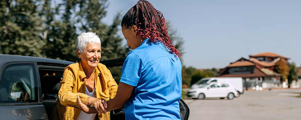 A Visiting Angels caregiver comforting an elderly woman with Alzheimer's, highlighting compassionate support in a peaceful home setting.