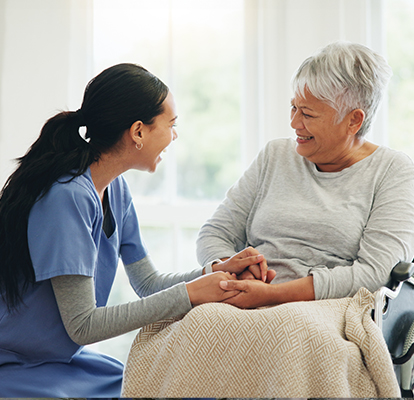 A Visiting Angels caregiver comforting an elderly woman with Alzheimer's, highlighting compassionate support in a peaceful home setting.