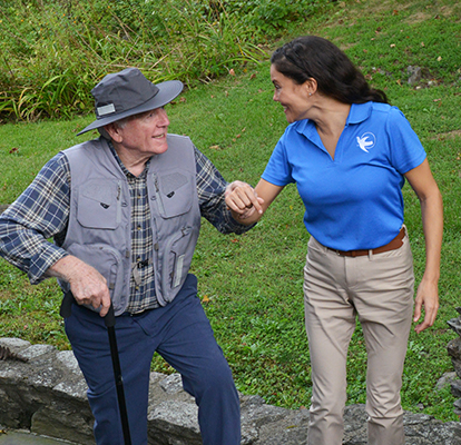 A Visiting Angels caregiver comforting an elderly woman with Alzheimer's, highlighting compassionate support in a peaceful home setting.