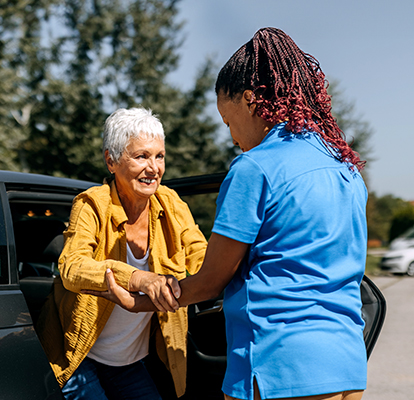 A Visiting Angels caregiver comforting an elderly woman with Alzheimer's, highlighting compassionate support in a peaceful home setting.